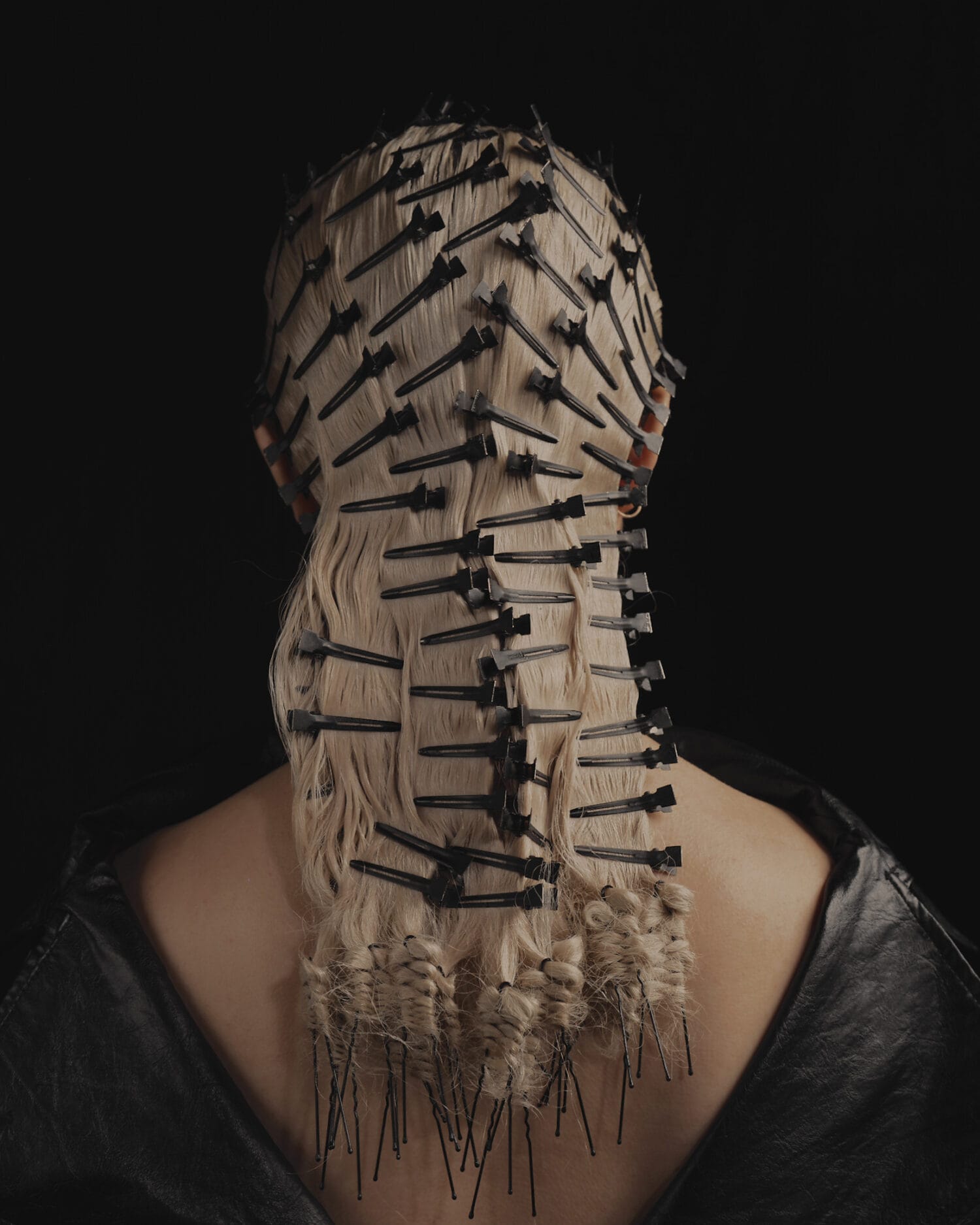 Blonde hair styled with black clips and pins