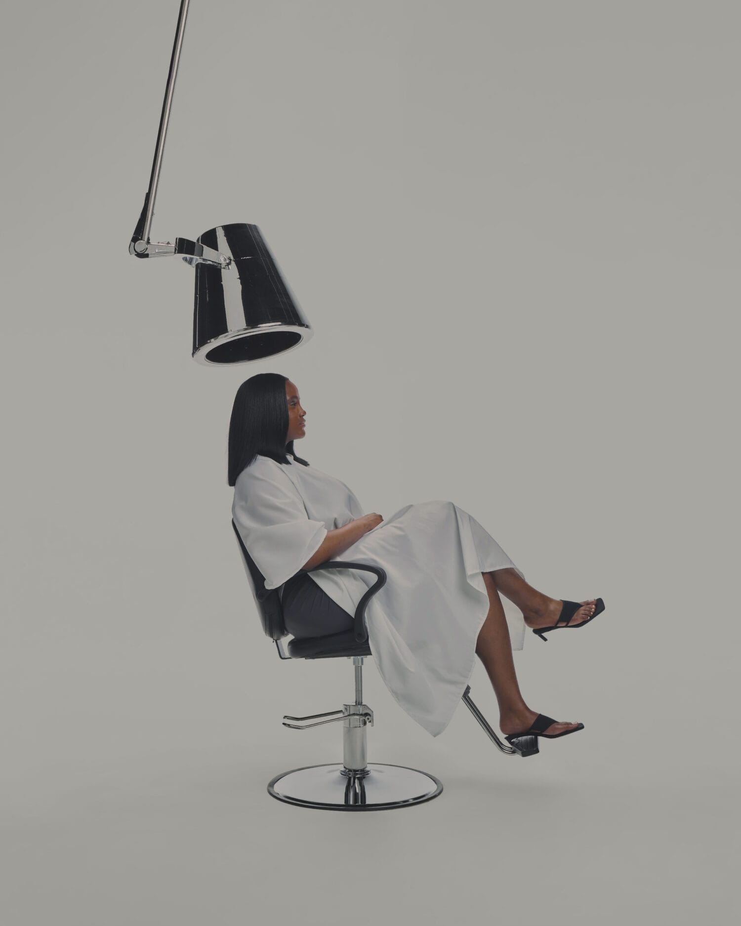 Woman seated in salon ready for haircare