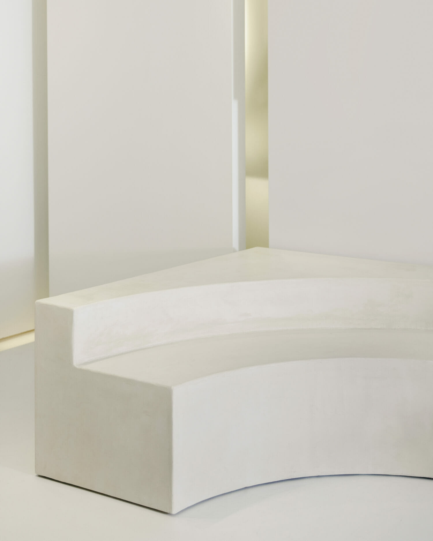 Sculptural curved white seating installation inside the somkhai store, highlighting the brand’s luxury interior aesthetic.