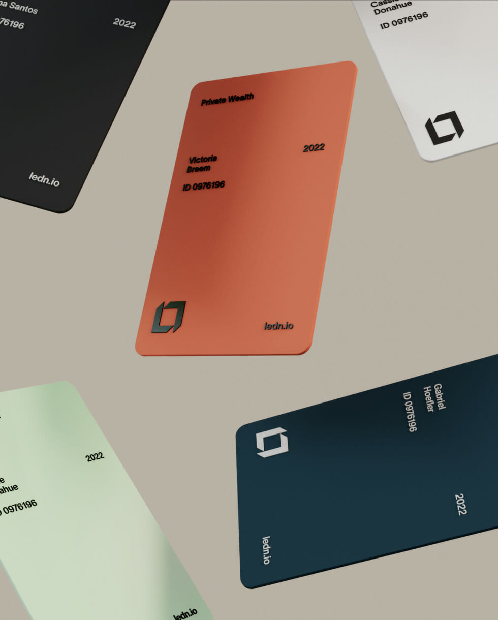 Collection of minimalist Ledn private wealth cards in coral, teal, black, and white colorways featuring clean typography and geometric branding displayed on a neutral background.