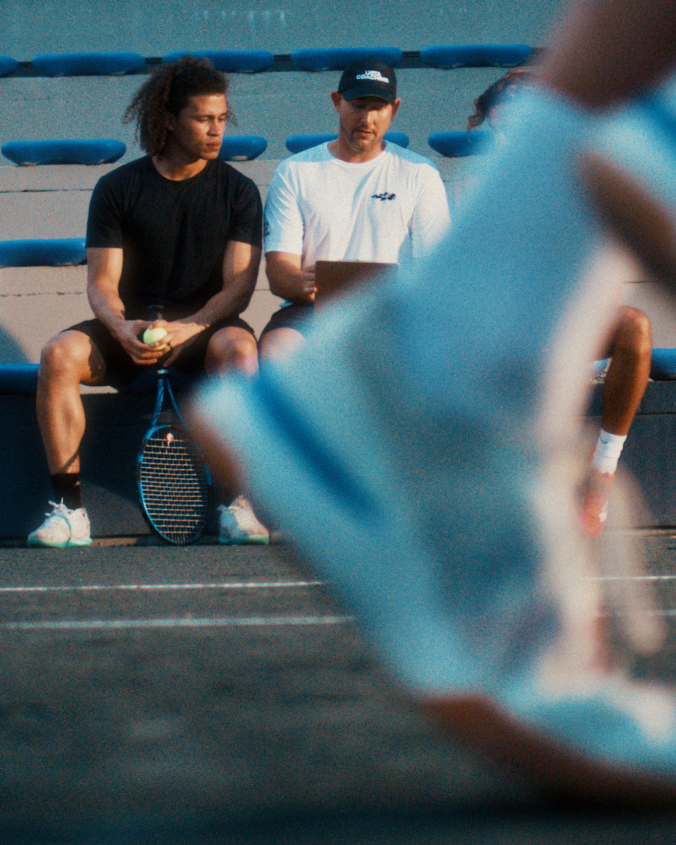 USTA coaching coach talking with his student about the game