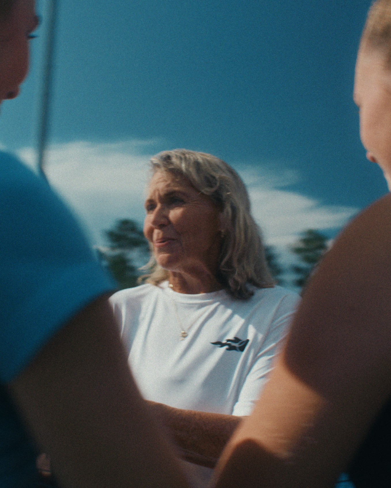 Image showing an old woman coach talking with young USTA coaches