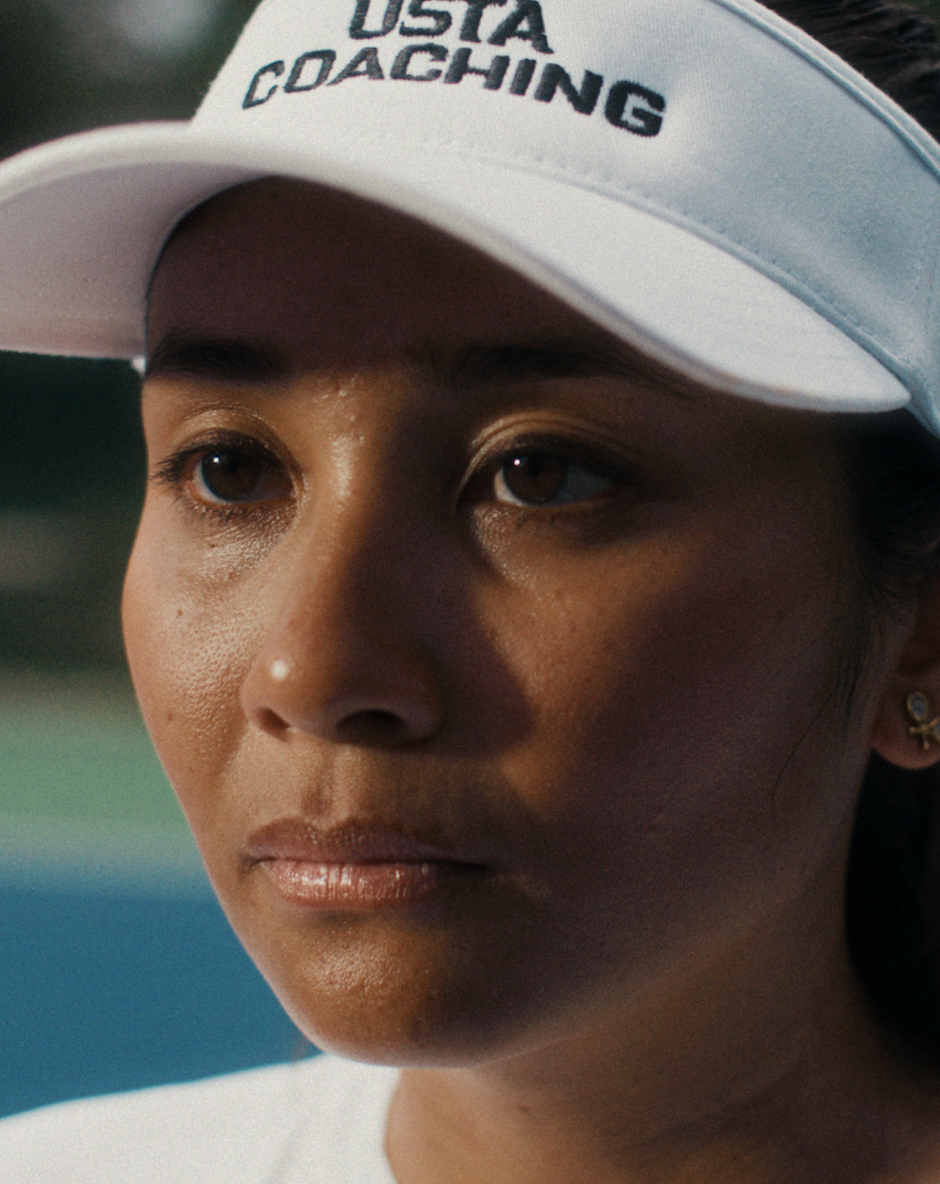 Girl wearing a USTA coaching cap representing the brand
