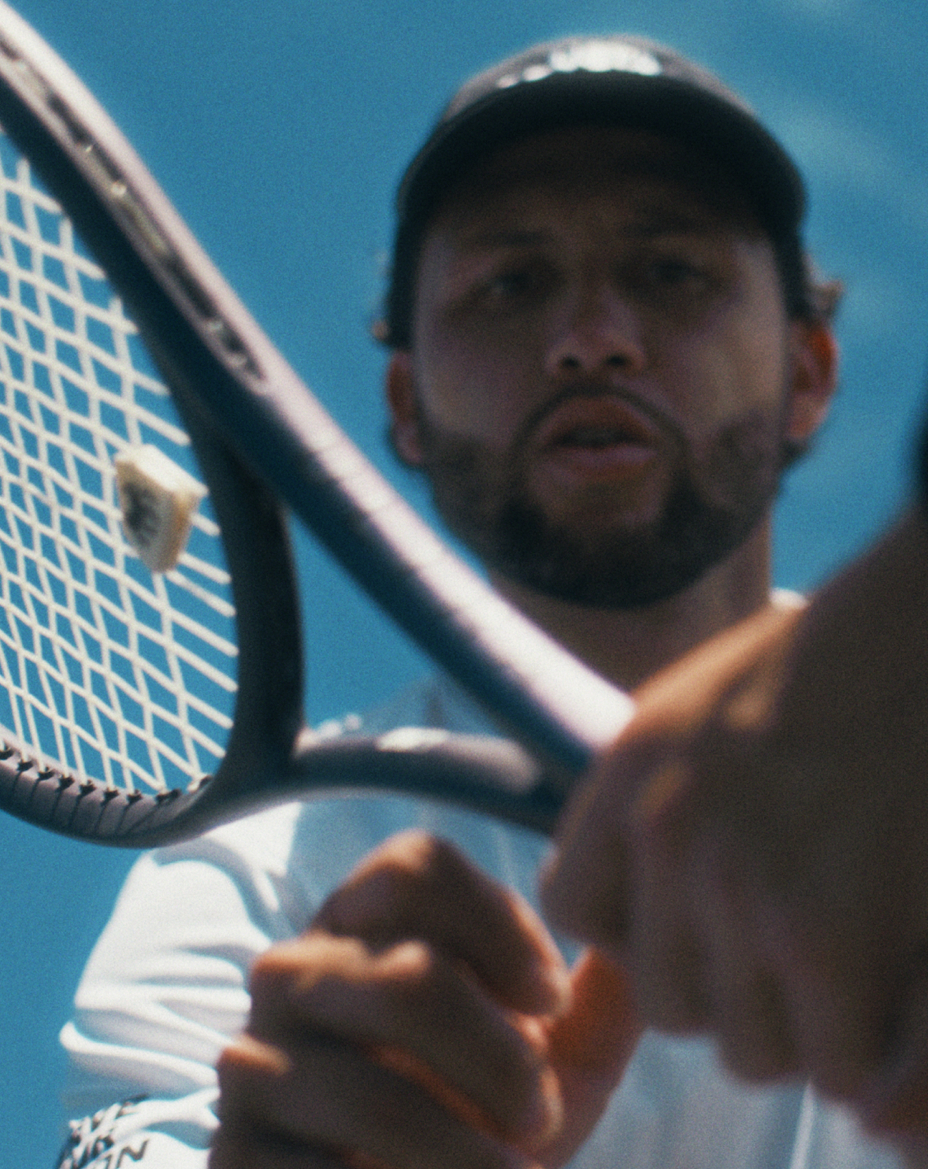 USTA coaching tennis coach grabbing a tennis racket