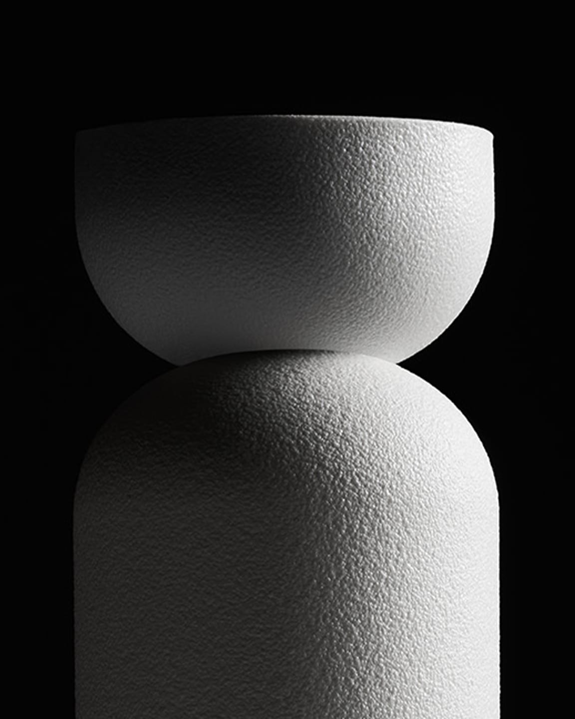 Textured white sculptural bottle design with stacked rounded shapes.