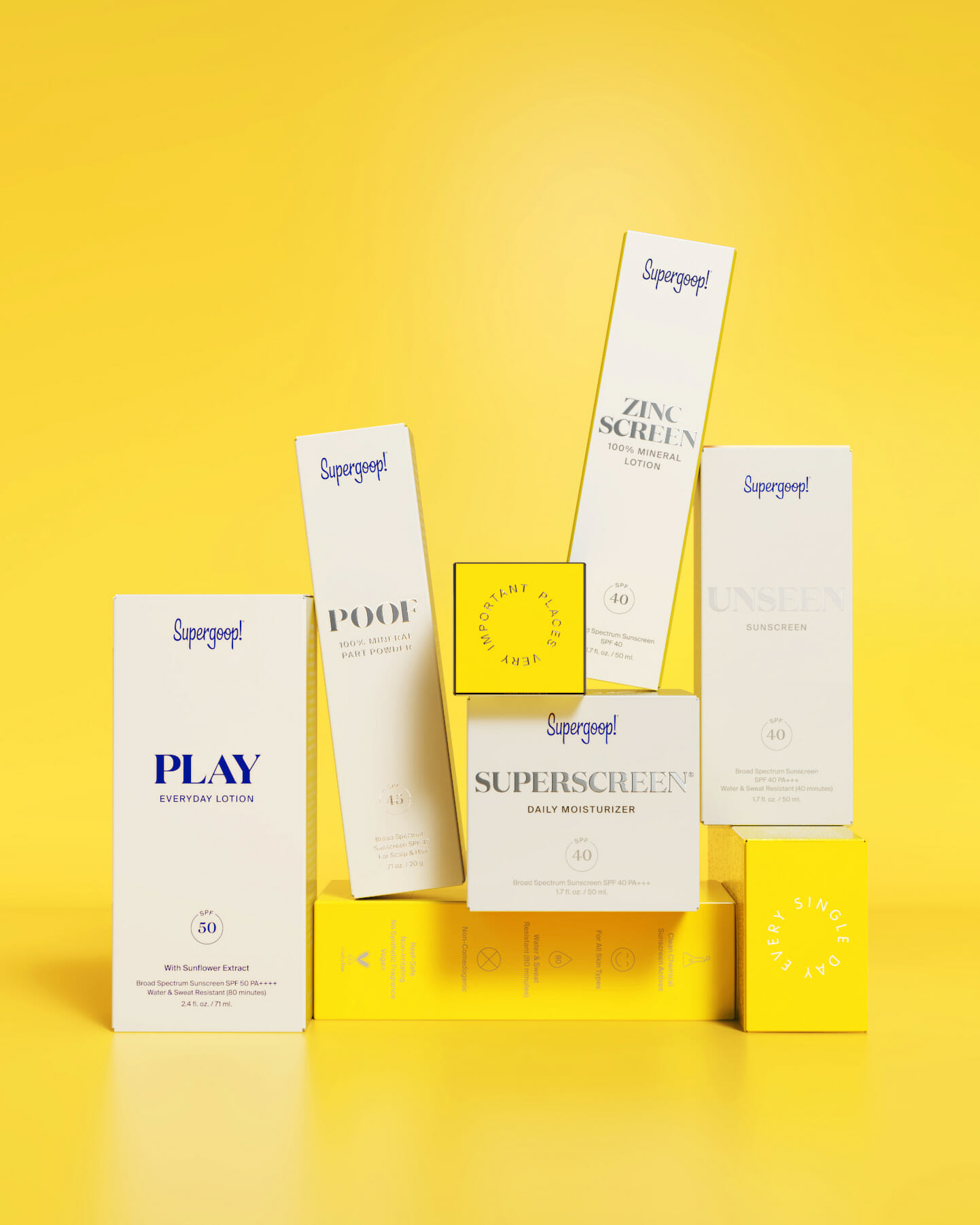 Minimalist Supergoop! skincare and sunscreen boxes arranged on a bright yellow background, featuring PLAY Everyday Lotion, Unseen Sunscreen, Superscreen, Zincscreen, and Poof Mineral Part Powder.