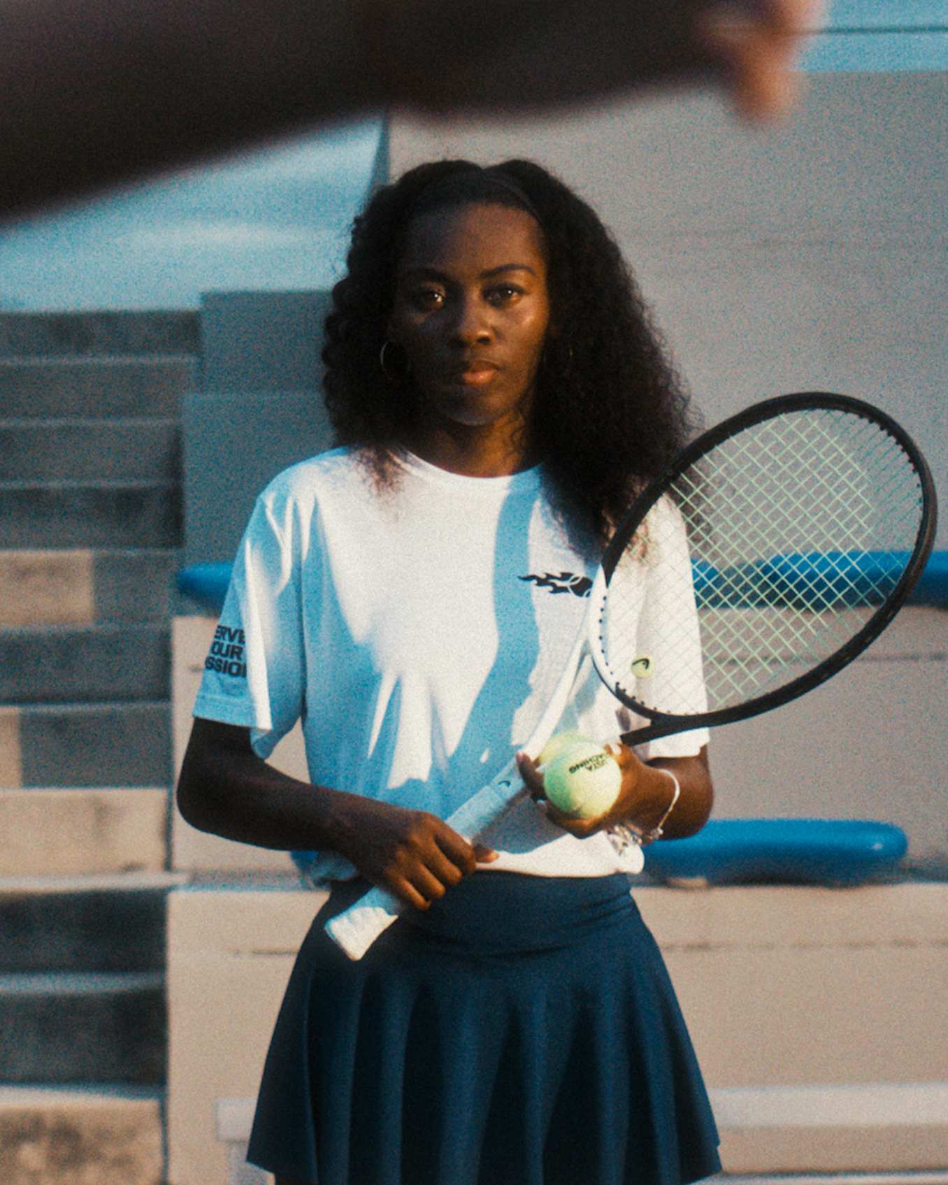 Girl holding a USTA ball and tennis ready for game practice