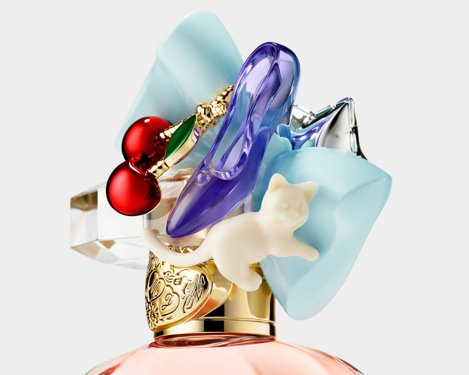 Creative bottle of perfect marc jacobs fragrance topper decorated with cherries, a purple high heel, silver star, pastel bows, and a white cat charm.