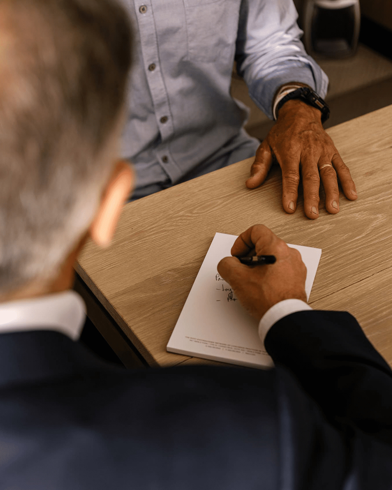 Warm and professional consultation scene showing a patient meeting with physicians from MD² in a private setting focused on personalized healthcare discussions and trust-based care.