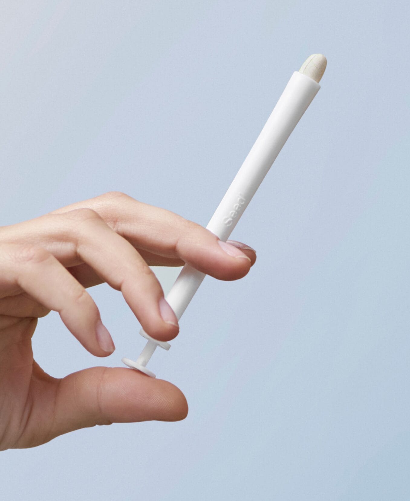 Seed vaginal applicator white color with a tablet.