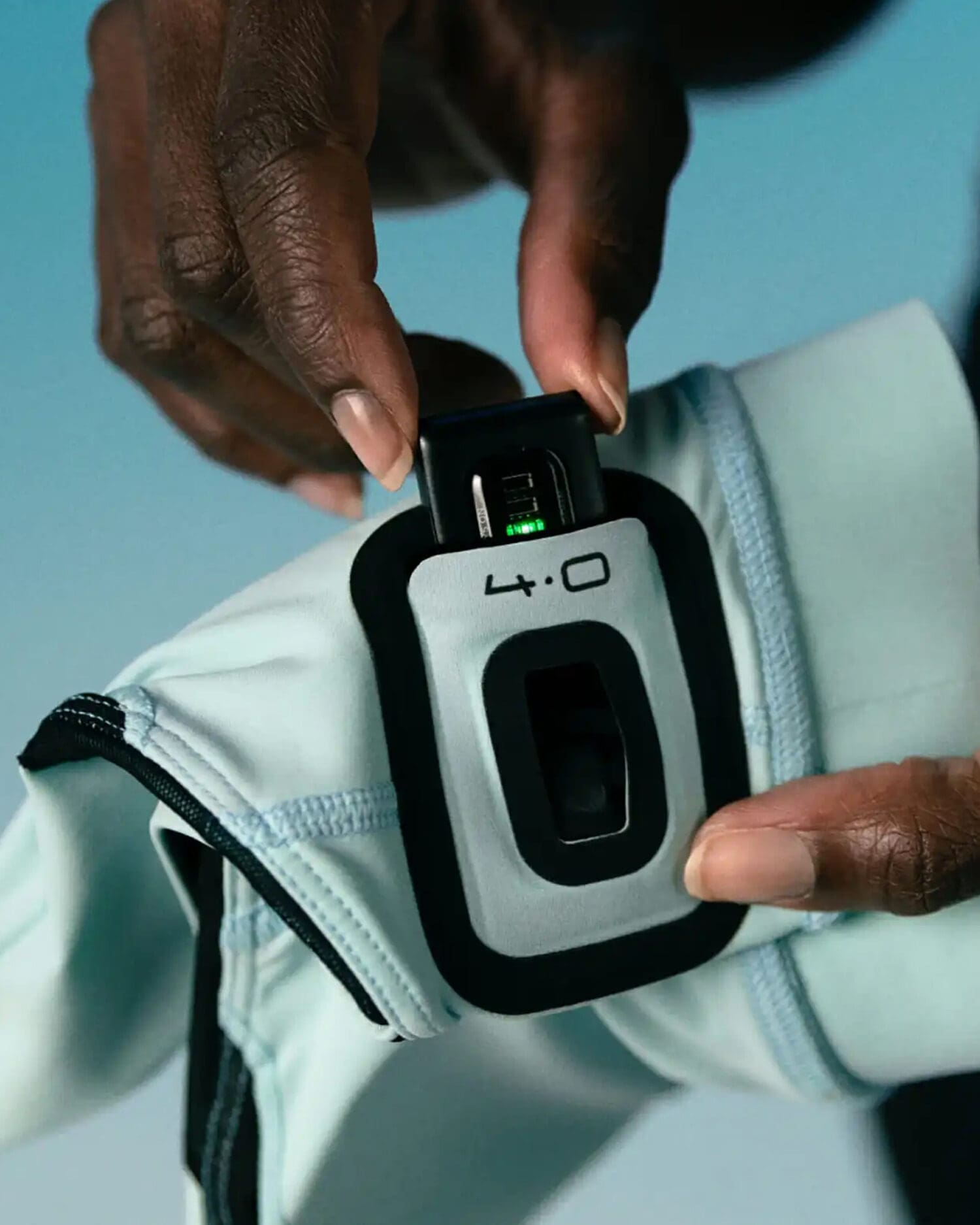 Professional athlete using a WHOOP biometric wearable sensor integrated into performance apparel for real-time health tracking