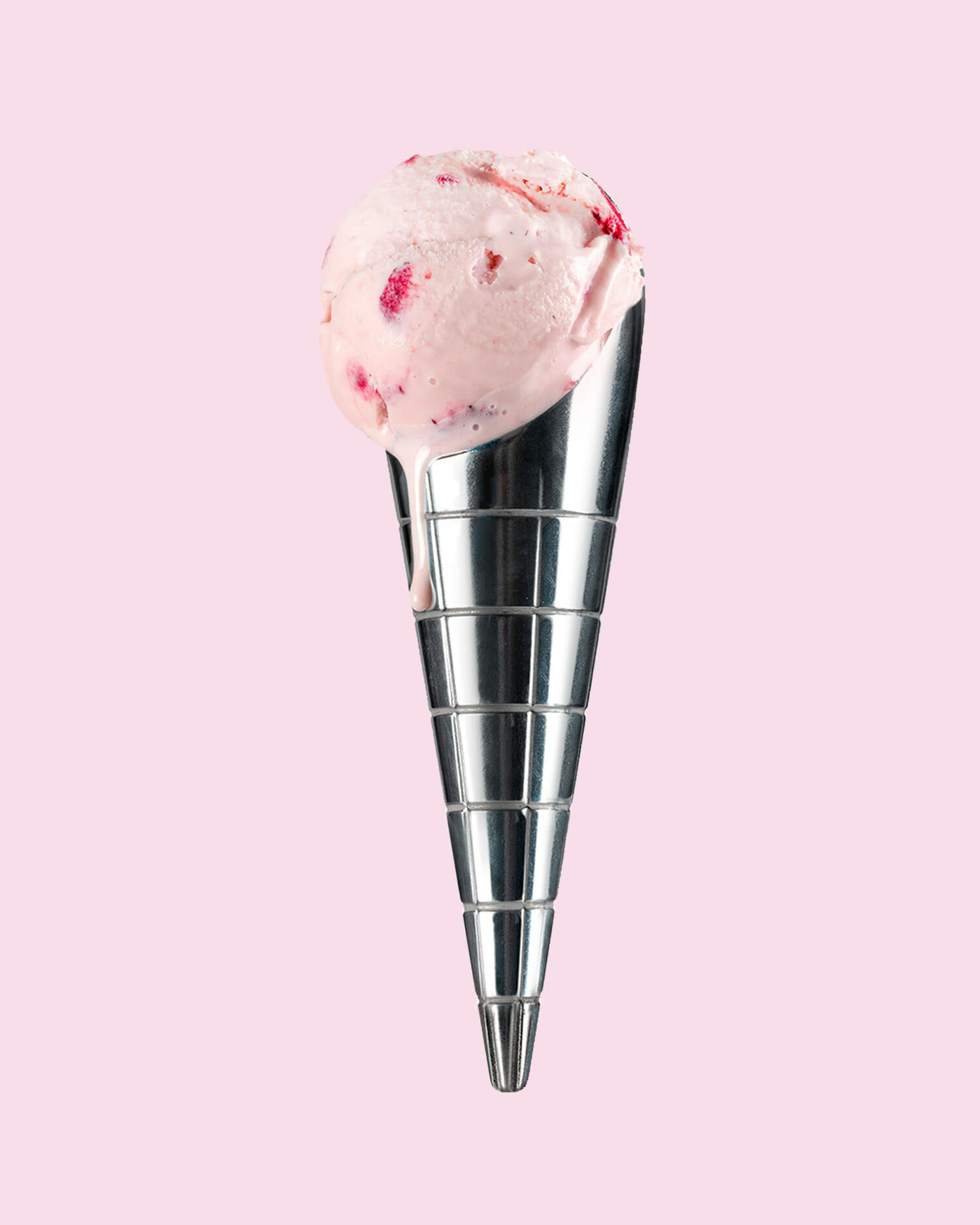 Stainless steel dipped ice cream scoop from moma design store displayed on a soft pink background.